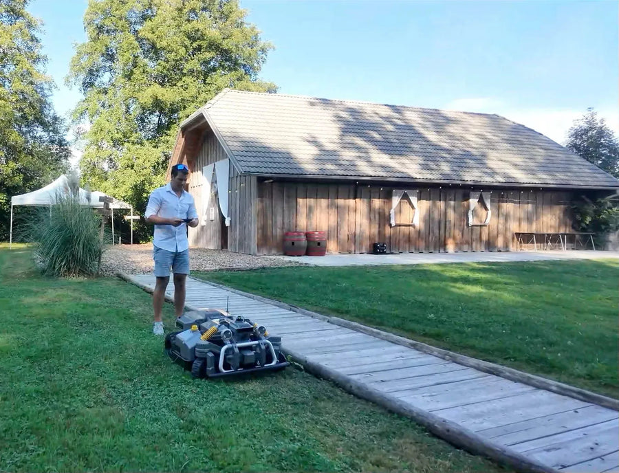 Maston mowing the lawn beside the barn at Skedenj 2